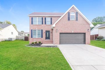 Madison house for rent - a brick house with a driveway and a garage door