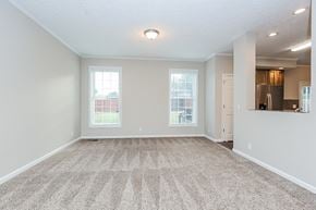 Madison house for rent - an empty living room with a kitchen and a window
