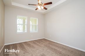 Winter Garden house for rent - a bedroom with carpet and a ceiling fan