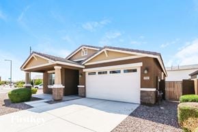 Buckeye house for rent - A house with a brown roof and a white garage door.