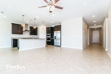 Buckeye house for rent - A spacious kitchen with a bar area and a ceiling fan.