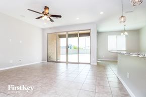 Buckeye house for rent - A spacious room with a ceiling fan and sliding glass doors.