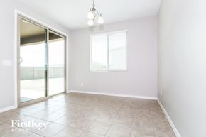 Buckeye house for rent - A room with a sliding glass door and a window with blinds.