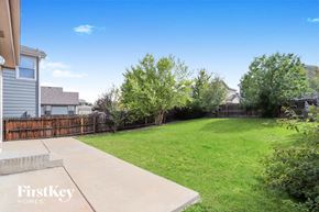 Aurora house for rent - a backyard with a grass lawn and a wooden fence