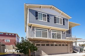Aurora house for rent - a blue and white house with a garage