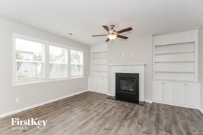 Austell house for rent - a living room with a fireplace and a ceiling fan
