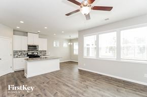 Austell house for rent - an open kitchen and living room with a ceiling fan
