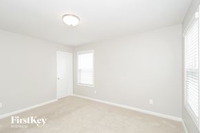 Austell house for rent - a bedroom with white walls and white carpet and a white door and window