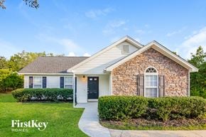 Gastonia house for rent - a small brick house with a sidewalk in front of it