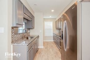 Gastonia house for rent - a modern kitchen with stainless steel appliances and granite counter tops
