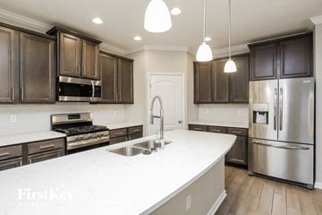 Middleburg house for rent - A kitchen with a white counter top and stainless steel appliances.