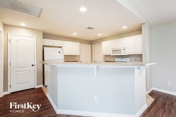 Lehigh Acres house for rent - A kitchen with white cabinets and a white island.