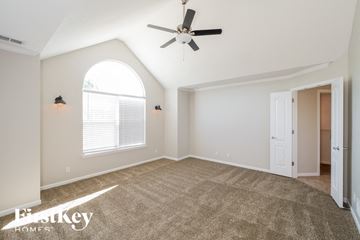 Shawnee house for rent - the living room with carpet and a ceiling fan