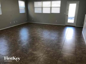 Phoenix house for rent - A room with tile flooring and a door leading to a balcony.