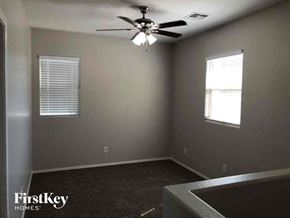 Phoenix house for rent - A room with a ceiling fan and two windows.