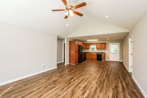 Dahlonega house for rent - A room with a ceiling fan and wooden floors.