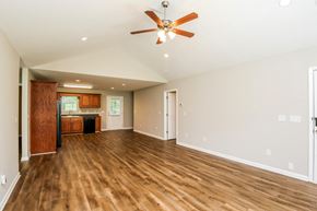 Dahlonega house for rent - A room with a ceiling fan and wooden floors.