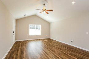 Dahlonega house for rent - A room with a ceiling fan and wooden flooring.