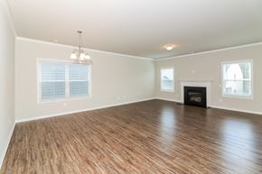 Canton house for rent - an empty living room with a fireplace and wooden floors