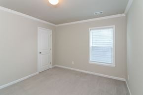 Canton house for rent - an empty bedroom with a door and a window