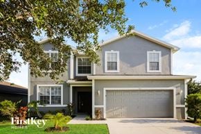 Lehigh Acres house for rent - A two-story house with a garage is showcased in the image.
