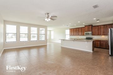 Jacksonville house for rent - A spacious kitchen and living room with a refrigerator on the right.