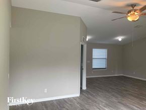 Lehigh Acres house for rent - a living room with a ceiling fan and a door to a closet
