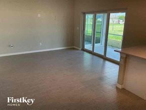 Cape Coral house for rent - A room with a sliding glass door and a wooden ledge on the wall.