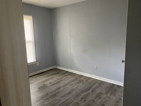 Monroe apartment for rent - A room with a grey wall and a wooden floor.