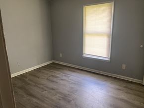 Monroe apartment for rent - A room with a window and wooden flooring.