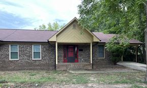 Monroe apartment for rent - A house with a red door and a brick wall.