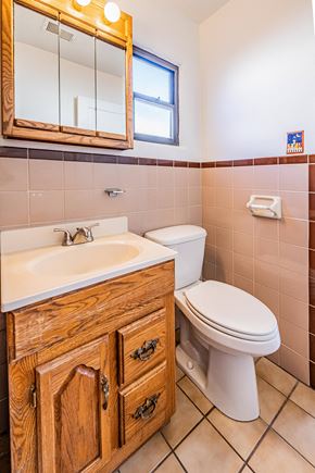 Albuquerque house for rent - a bathroom with a toilet and a sink and a mirror