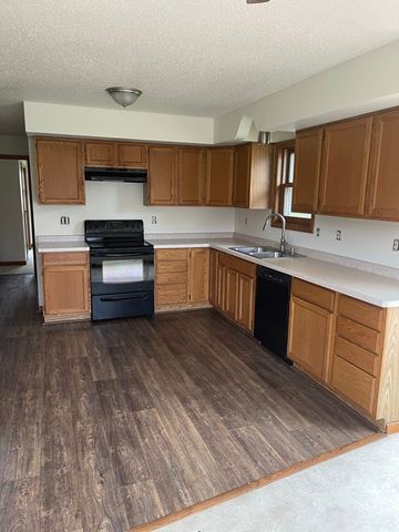 Weston apartment for rent - a kitchen with wooden cabinets and a stove and a sink