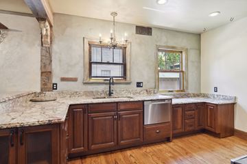 Minneapolis apartment for rent - A kitchen with wooden cabinets and a marble countertop.