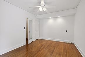 Minneapolis apartment for rent - A room with a ceiling fan and wooden floors.