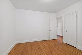 Minneapolis apartment for rent - A room with white walls and wooden flooring with two doors.