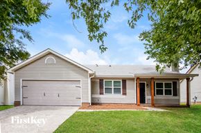 Charlotte house for rent - A two-car garage with a brown door is attached to a house.