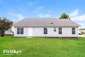 Greensboro house for rent - the front view of a white house with a grassy yard