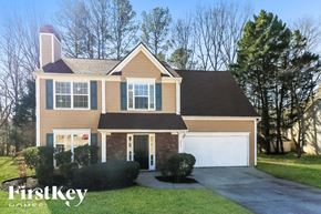 Austell house for rent - A house with a brown roof and a white garage door.
