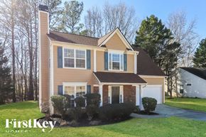 Austell house for rent - A house with a brown roof and a white garage door.