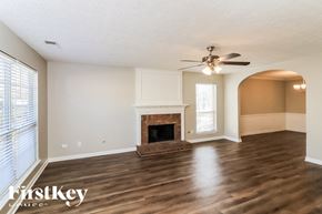 Austell house for rent - A spacious living room with a fireplace and hardwood floors.