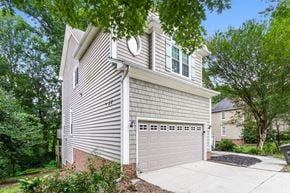 Greensboro house for rent - A house with a garage and a driveway.