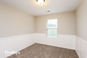 Dawsonville house for rent - a bedroom with white walls and carpet and a window