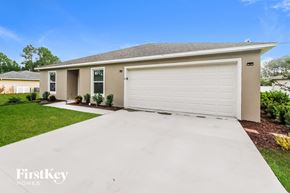 Palm Coast house for rent - a white driveway in front of a house with a white garage door