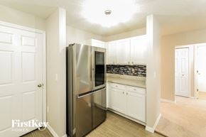 Palm Coast house for rent - a kitchen with white cabinets and a stainless steel refrigerator