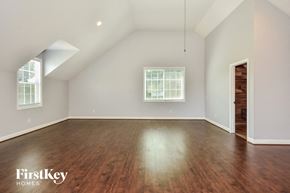 Mount Juliet house for rent - the living room with hardwood floors and a vaulted ceiling