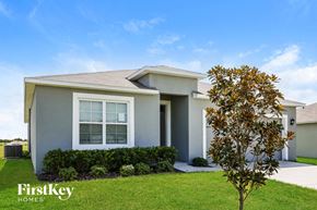 Auburndale house for rent - a white house with a tree in front of it