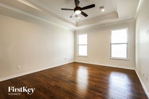 Mustang house for rent - a living room with wood floors and a ceiling fan