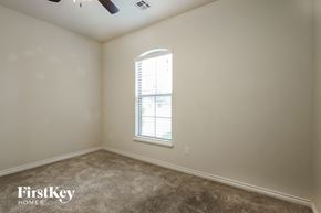 Mustang house for rent - a bedroom with a window and a carpeted floor