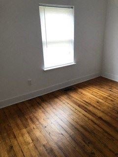 Franklinton apartment for rent - an empty room with a window and wooden floors